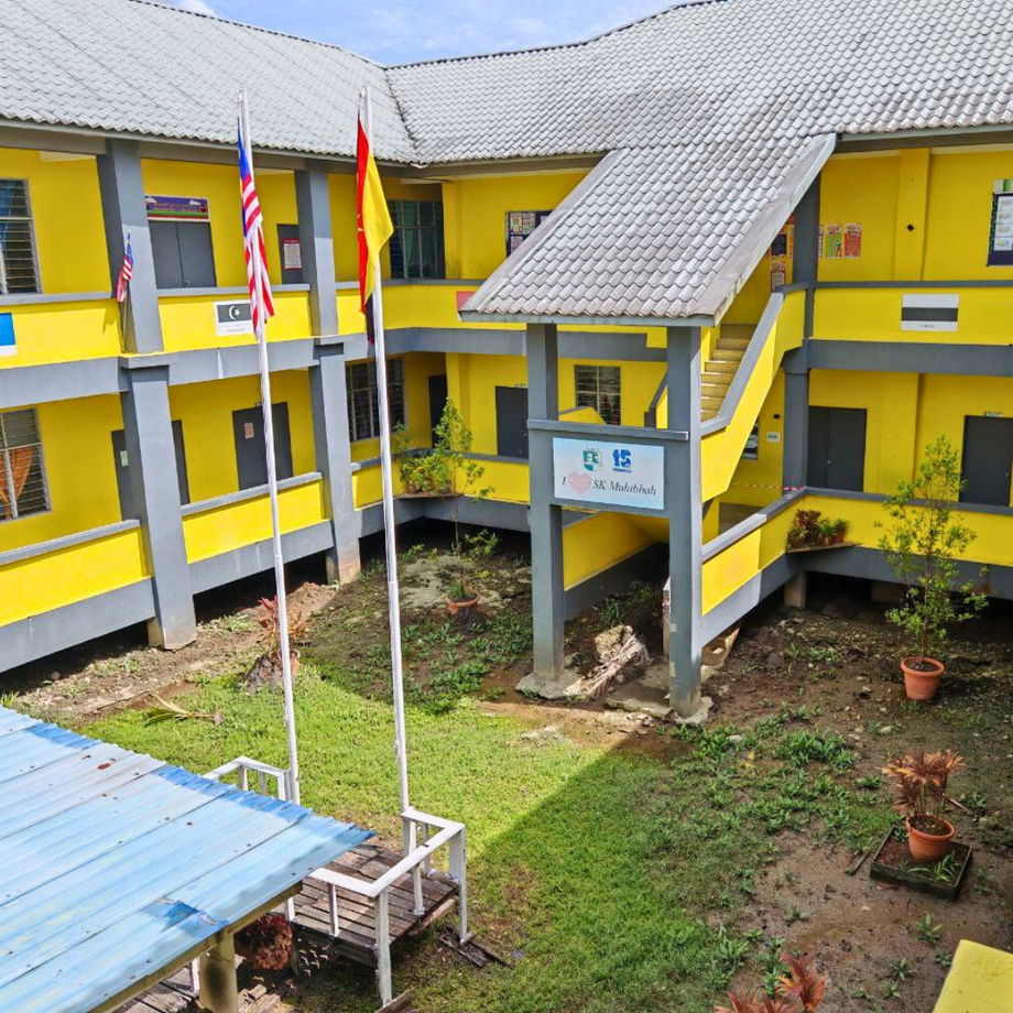 exterior view of SK Muhibbah school showing raised timber boardwalks and building structures
